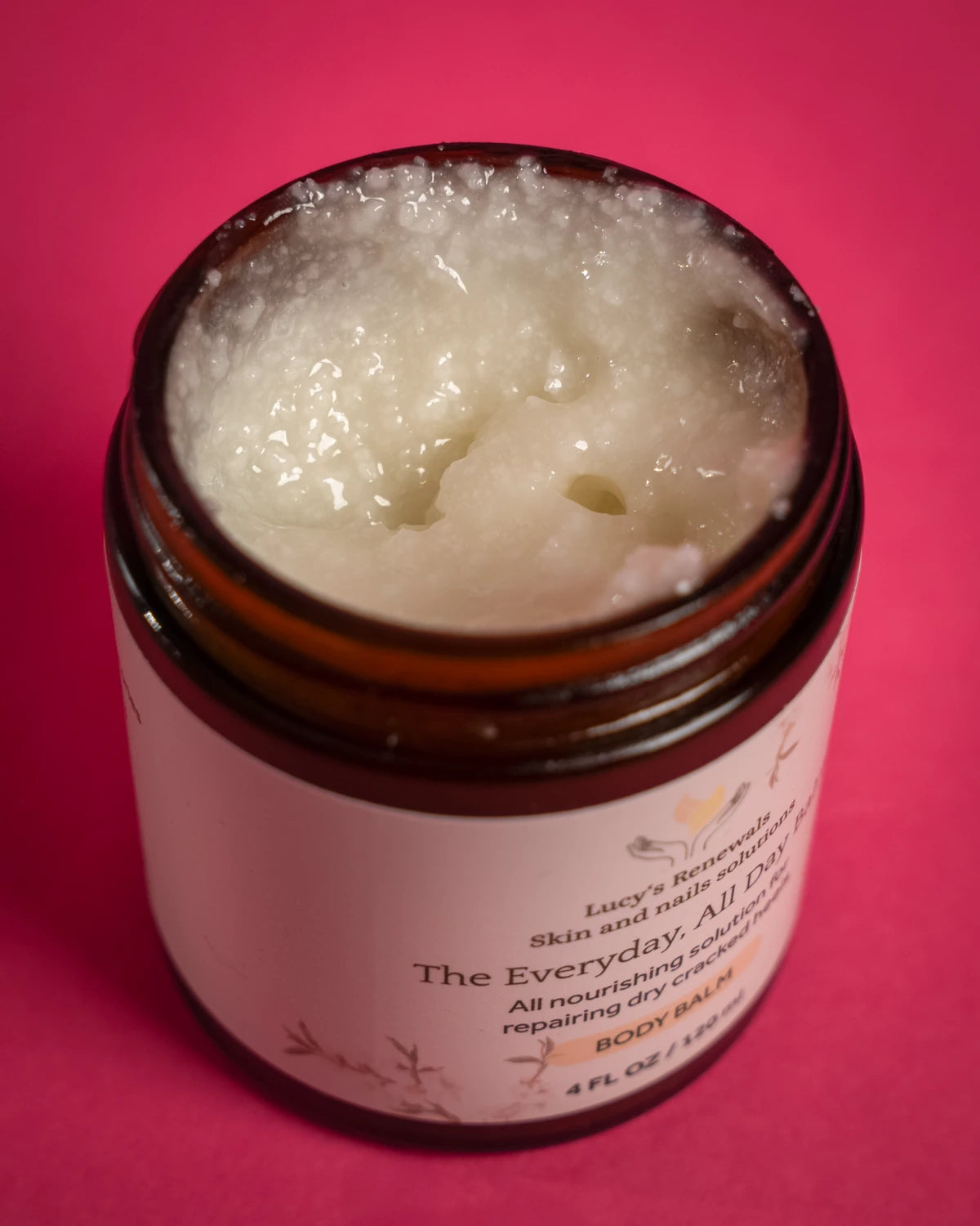 The actual rich balm texture inside an open Lucy’s Renewals jar